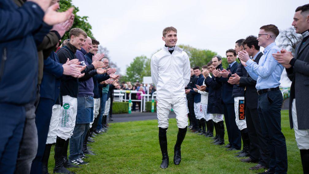 Harry Cobden receives a warm welcome from his weighing room colleagues as he claims his first jump jockeys' title